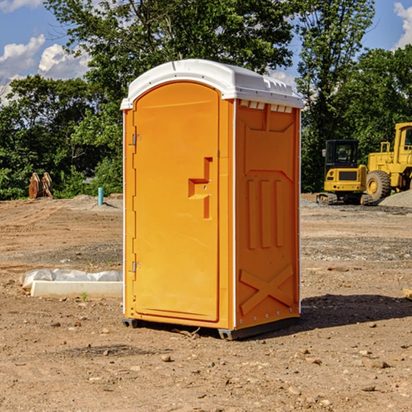 what is the cost difference between standard and deluxe portable restroom rentals in Amboy